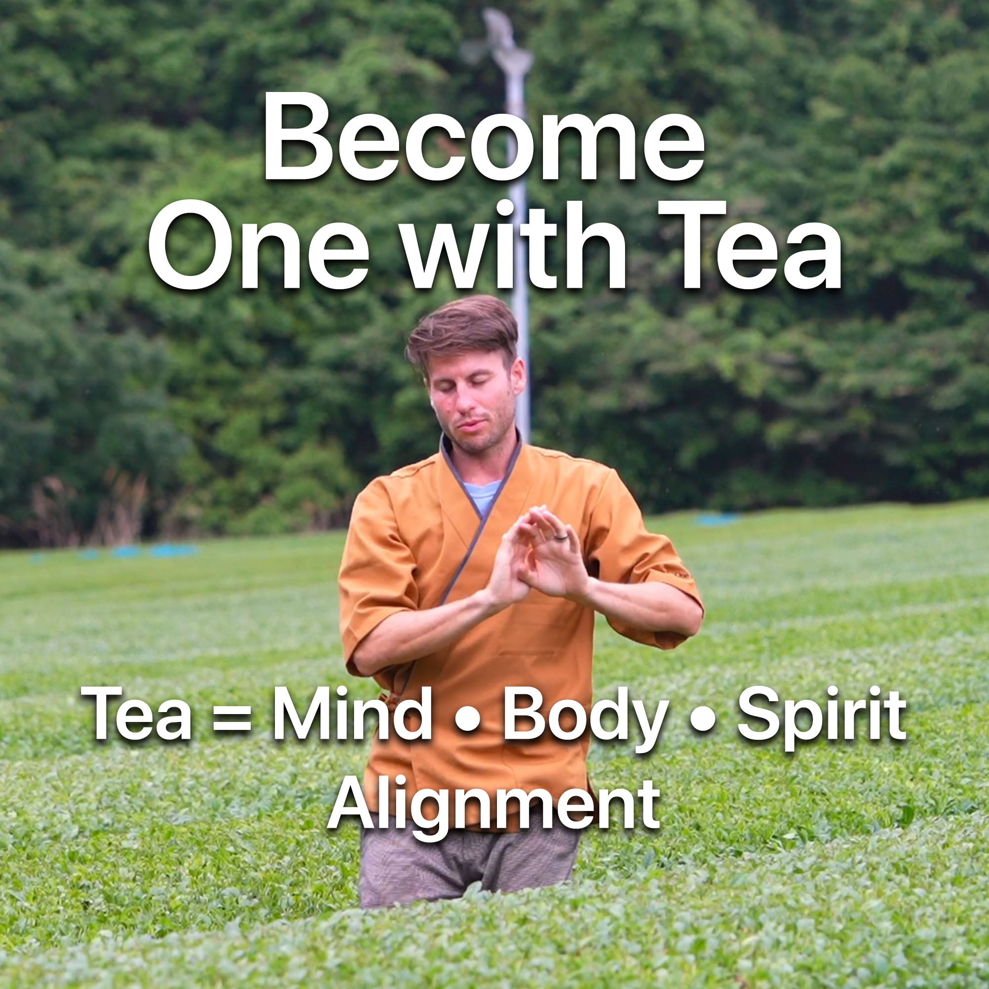 Man in mustard-colored kimono meditating in green tea field, promoting mindfulness with ONE WITH TEA branding.