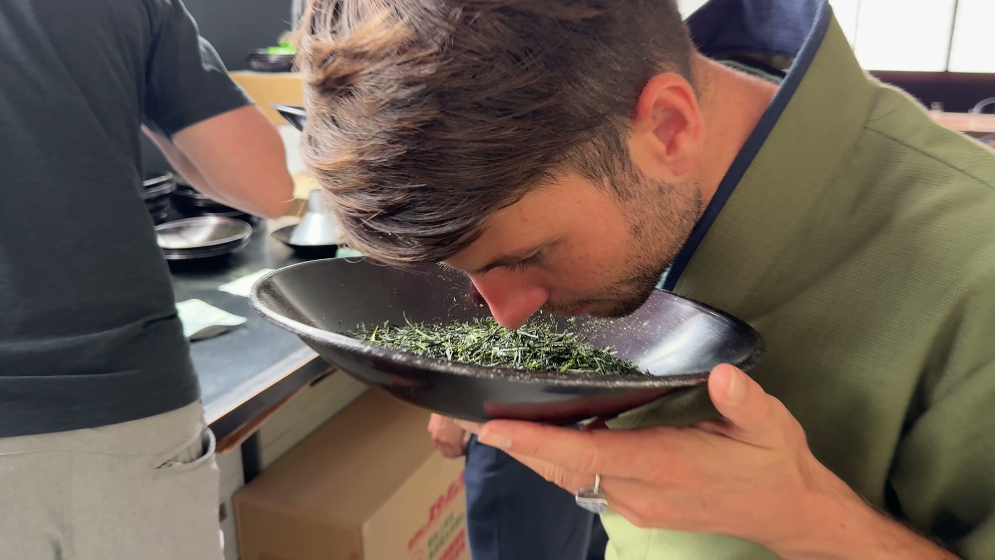 Christian Mauerer, founder of One with Tea, smelling fresh gyokuro leaves at Maruyasu in Kyoto