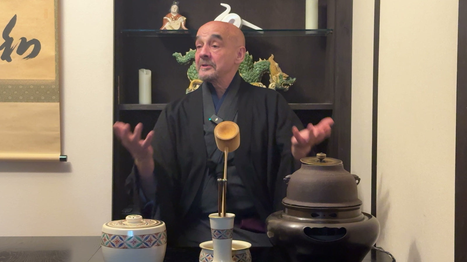 A tea master with matcha utensils in a tea-ceremony setting