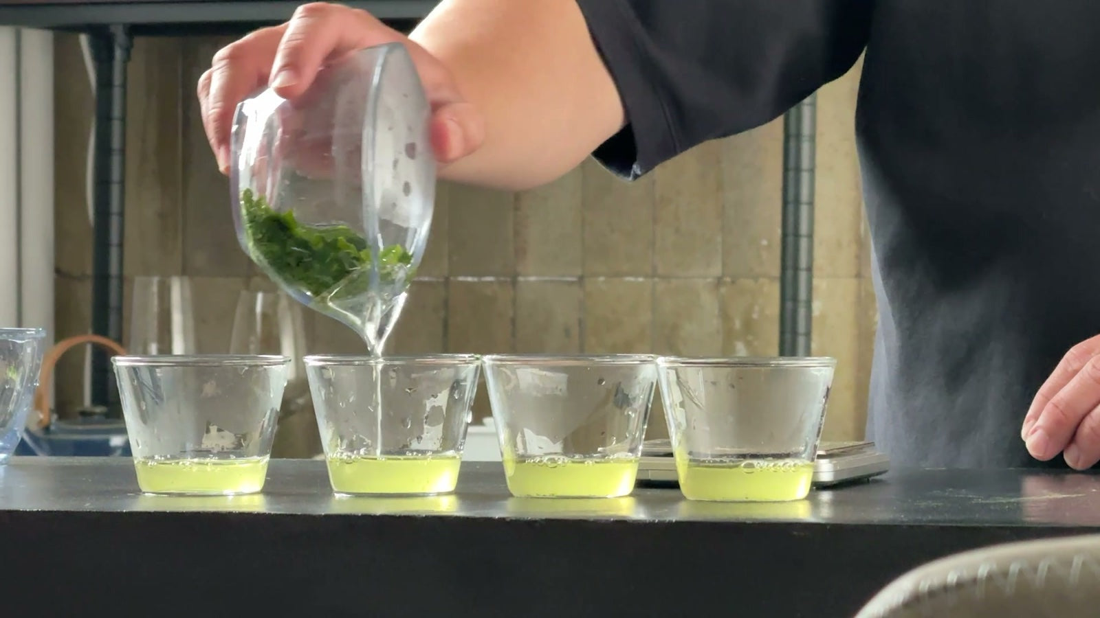 Freshly brewed Japanese green tea poured into tasting glasses