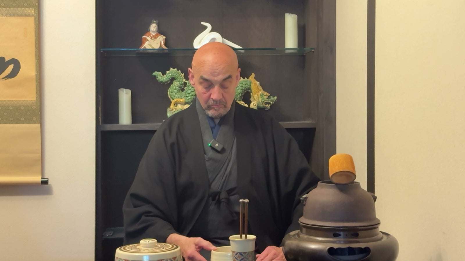 A tea master preparing matcha in a calm tea-ceremony setting